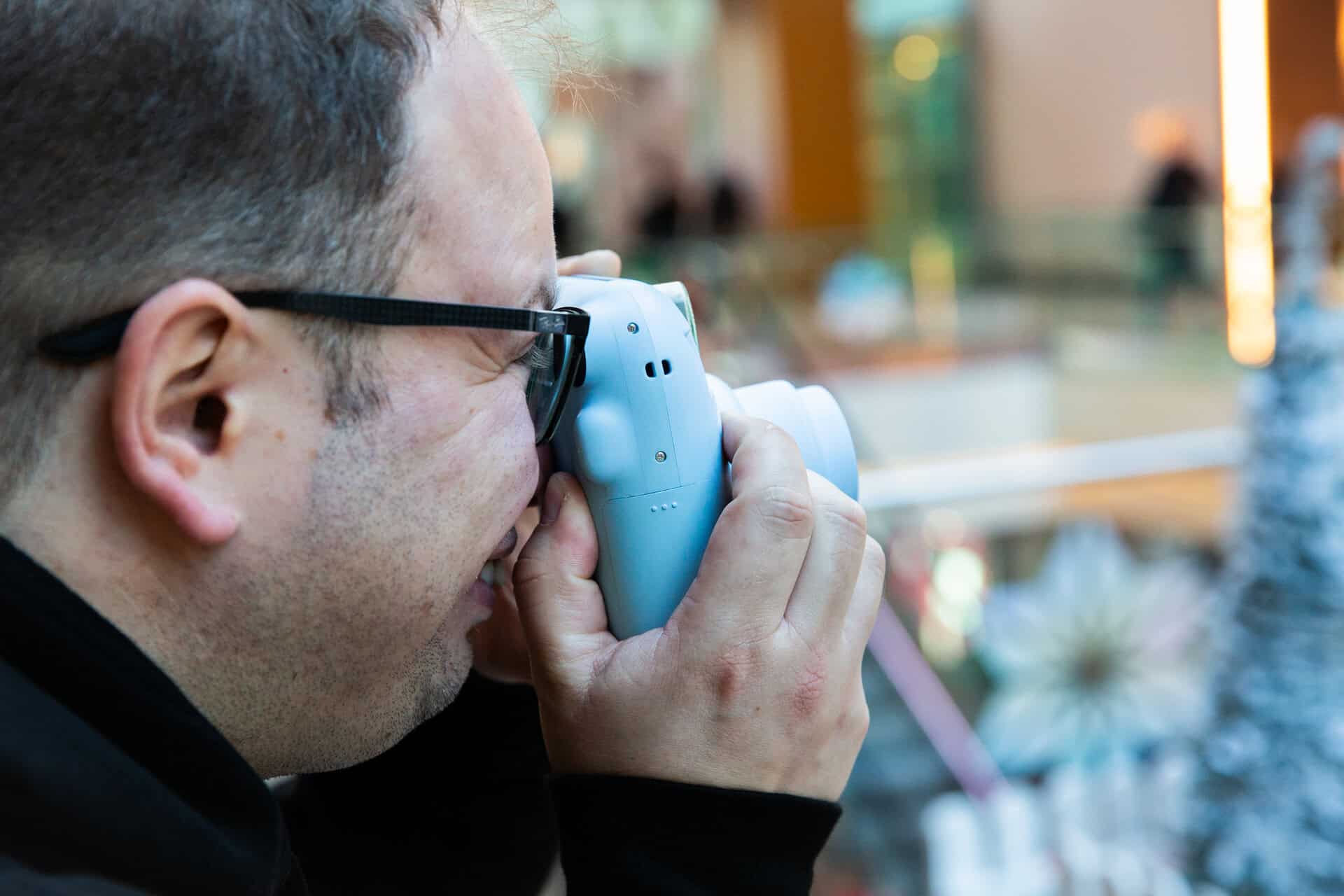 Tomasz Dyl (Founder and Managing Director of GottaBe!) taking pictures on a polaroid camera.